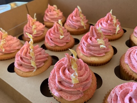 Strawberry cupcakes with pink buttercream and candied lemon